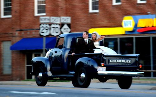 Newlyweds in back of pickup truck on a spring Saturday in Salisbury.