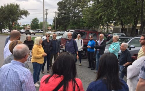 The May 6 Munching Tour organized by residents of the Grove Park neighborhood drew a crowd. Walk leaders were local historian Tom Hanchett, center, and Mimi Davis, in yellow. Photo: Ashley Clark