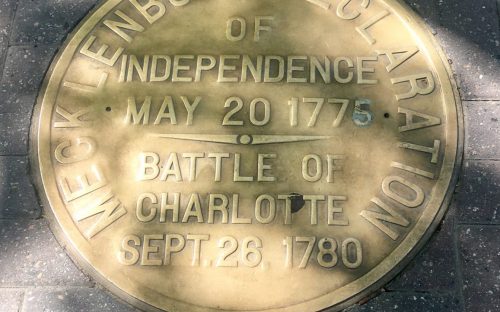 Participants in the May 20 City Walk led by Scott Syfert saw this plaque in the sidewalk at Trade and Tryon streets. It commemorates the story, never fully verified, of a May 20, 1775, declaration of independence in the small hamlet named Charlotte. The declaration is known as the Meck Dec. Photo: Mary Newsom