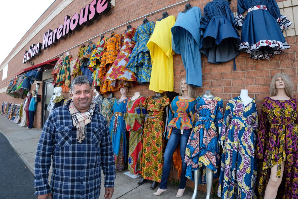 Owner George Saini bought land next to his Fashion Warehouse for more parking when the light rail right-of-way and sidewalk took most of the existing parking lot in front of the building, near the Tom Hunter Station. Each evening, it takes him about a half hour to take all the clothes back inside his store. Photo: Nancy Pierce