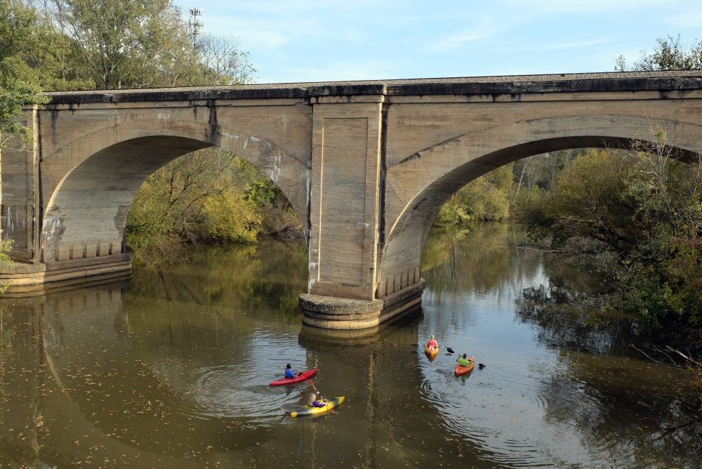 Paddlers on the South Fork at the Norfolk Southern Railroad trestle in Cramerton. Photo: Nancy Pierce.