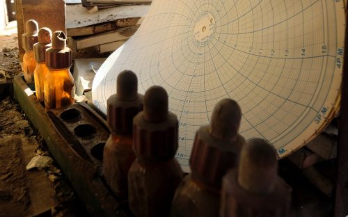 A flow meter graph and bottles of phenolphthalein, used to test acidity levels in water, may have passed decades in this same dusty spot inside the boiler house.