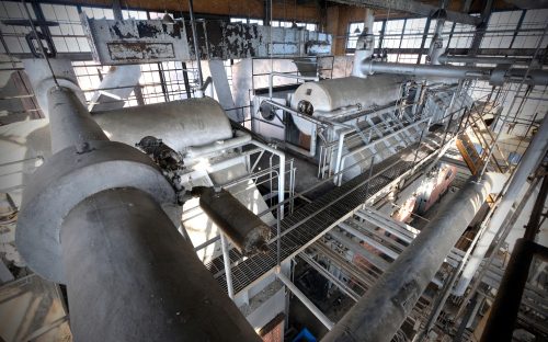 Natural light from all four sides of the three-story boiler house streams over the old boiler mechanism.