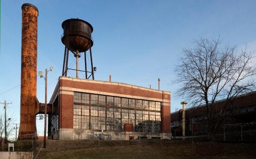 The 1924 factory building along Statesville Avenue, with its rusted steel smokestack and capacious windows, is destined for renovation and reuse. All photos: Nancy Pierce