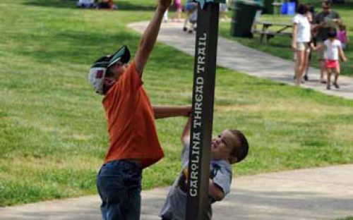 Children play next to the Carolina Thread Trail sign at the Anne Springs Close Greenway in April 2010.