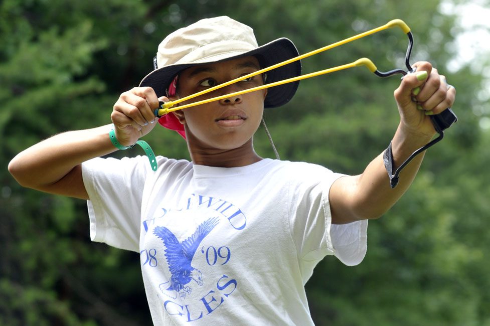 A Charlotte girl takes aim, at the Girl Scouts' Camp Ginger Cascades.