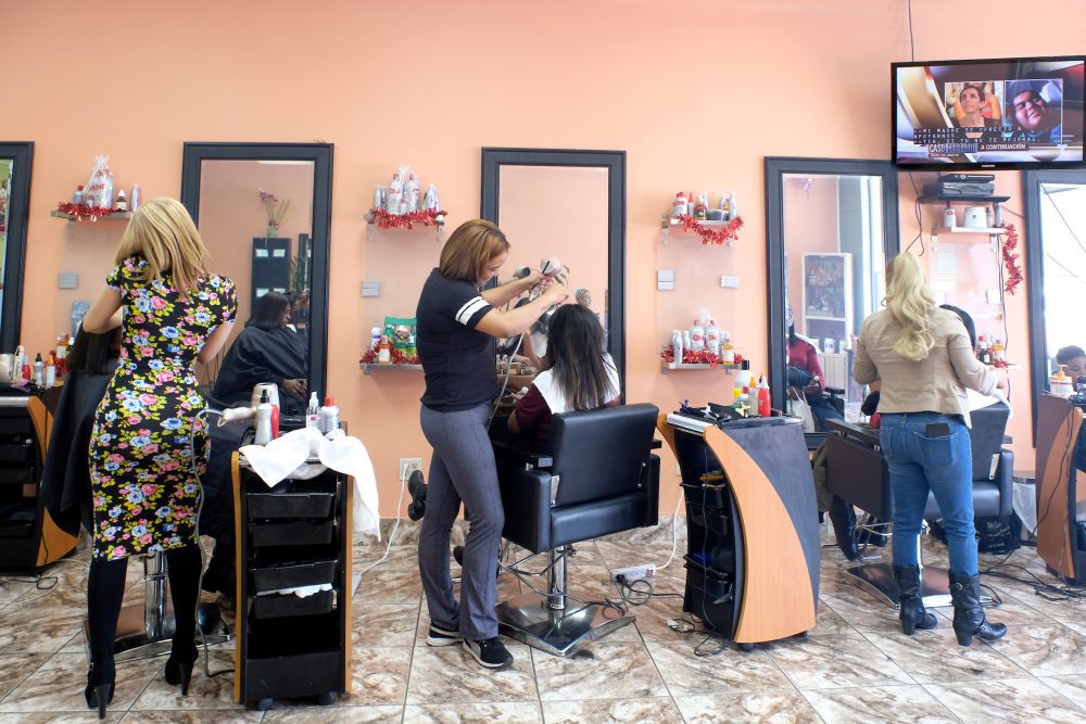 All the stalls were booked on a weekday afternoon at Mery Mi Salon at the North Pointe Plaza near the Old Concord Road Station: The shop’s front window prominently advertises a Dominican stylist. Photo: Nancy Pierce 