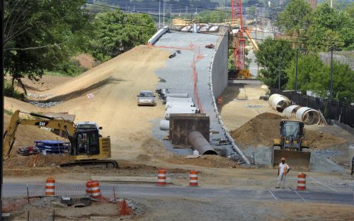 A retaining wall rises up to the bridge over the CSX freight rail tracks. View is looking east from 12th Street, June 11, 2015. Photo: Nancy Pierce