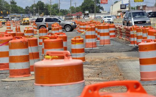 For months, construction barrels have decorated North Tryon Street, where the Blue Line Extension will run in the median. These are near Orr Road. Photo: Nancy Pierce