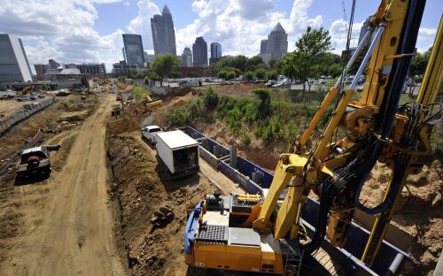 A view of the Charlotte skyline from the construction site at East 11th Street. The rig is drilling a hole to set piles for panel wall construction. Photo: Nancy Pierce