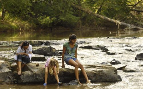 Children play along the South Fork River in September 2009 near what's now the Carolina Thread Trail.