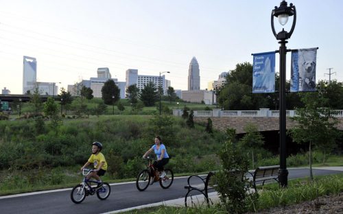 Bikers ride along the Little Sugar Creek greenway in August 2010.