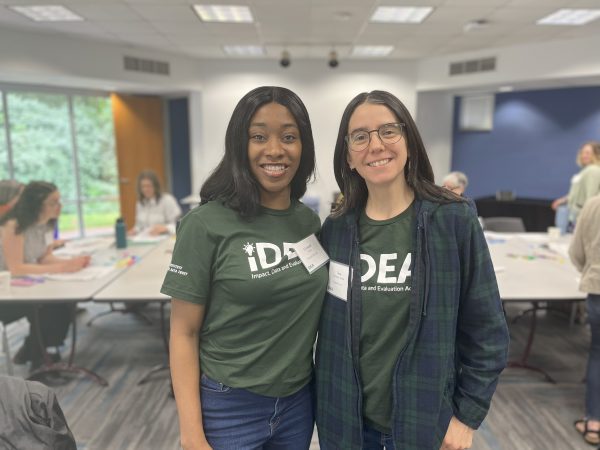 Two women smiling in the pilot course of Evaluation Explorations.