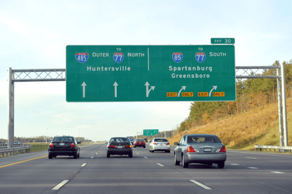 A photo of road signs heading north on I-77 toward Huntersville.