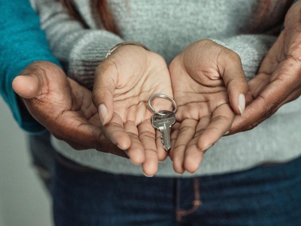A couple holding a set of house keys.