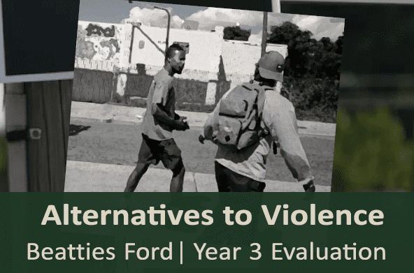 Photo of two men walking together in a neighborhood.