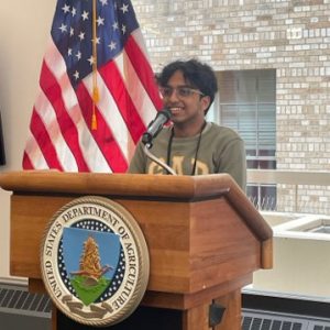 Vrishab Nooka speaks at a government office.