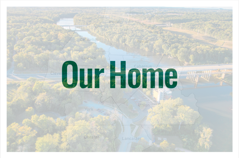 The front of a post card with "Our Home" text on the front and muted image of the Catawba River flowing through Rock Hill, SC in the background.